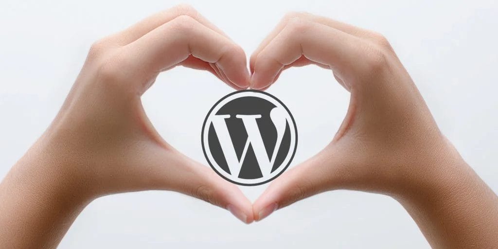 Heart shaped hands over the WordPress logo